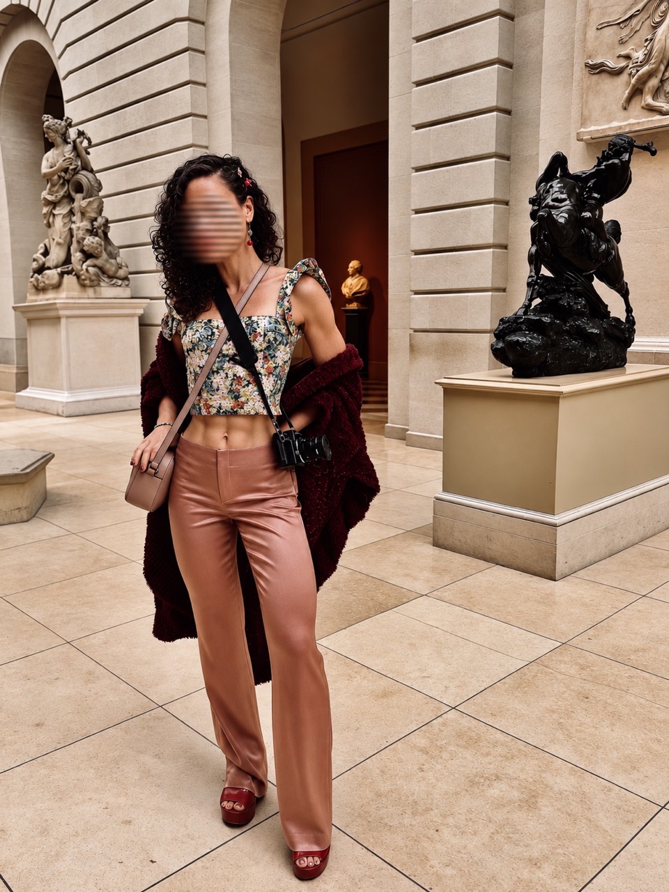 Full-length portrait in a floral corset and rose trousers in an art gallery