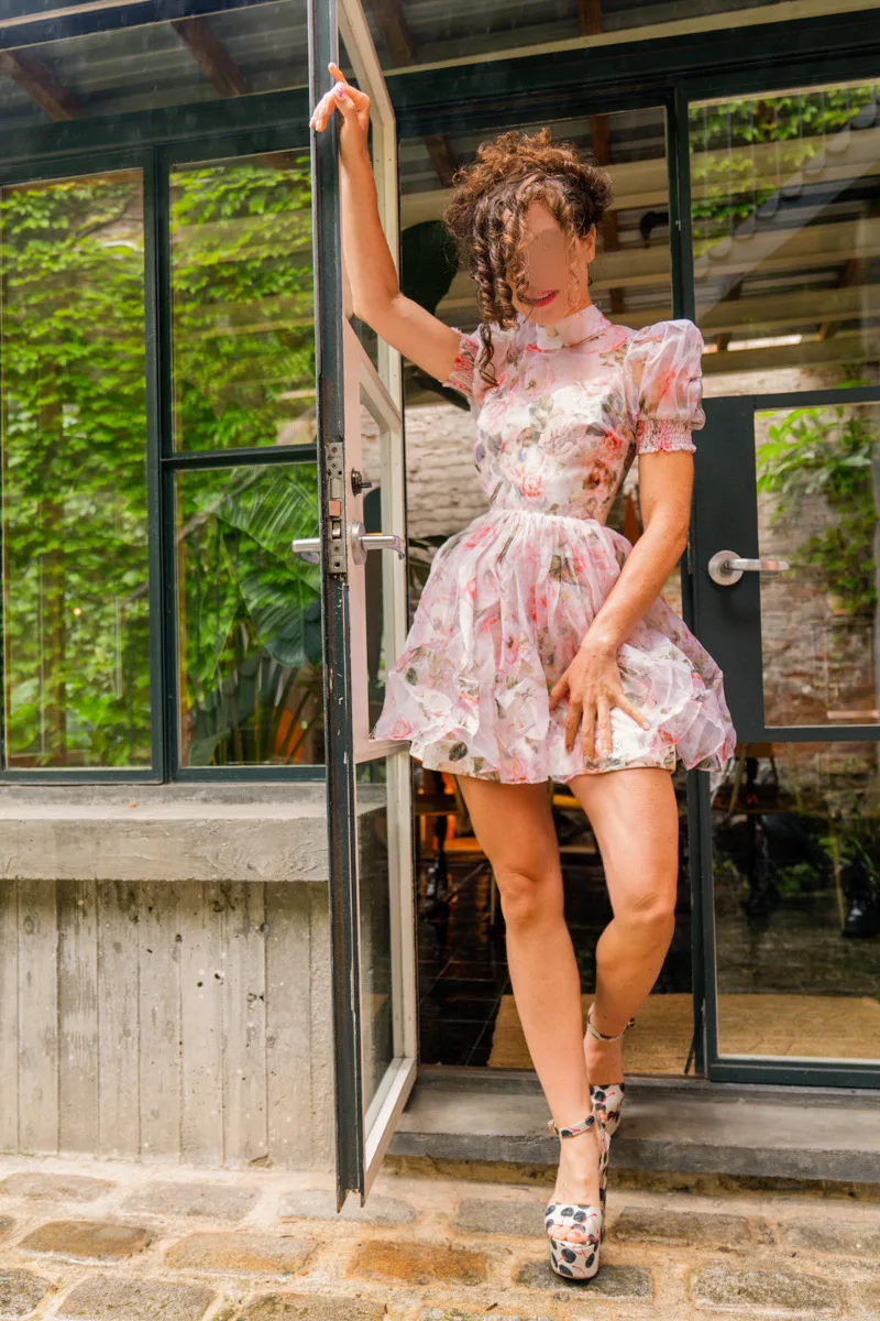 Playful full-length portrait in a floral dress
